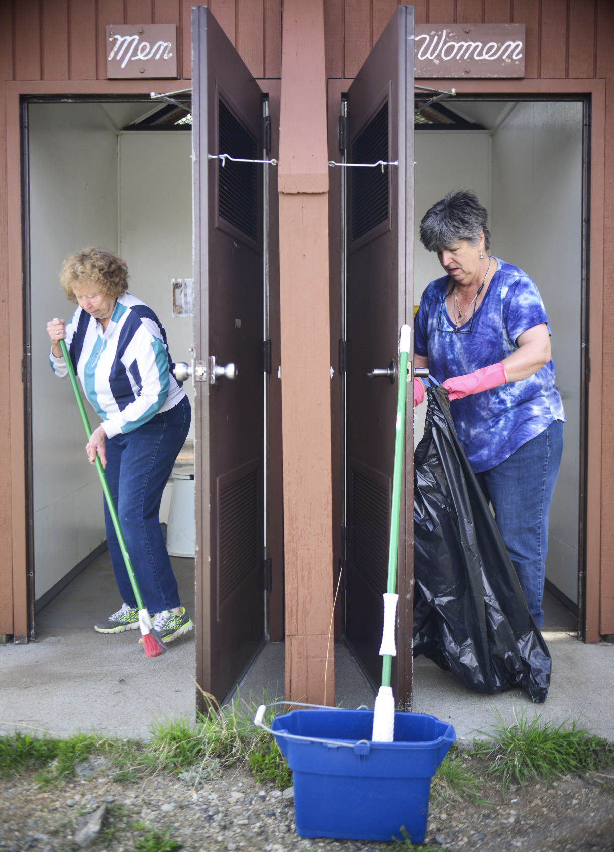 Candy Sweem, left, and Jane Clark work to clean out the permanent bathrooms